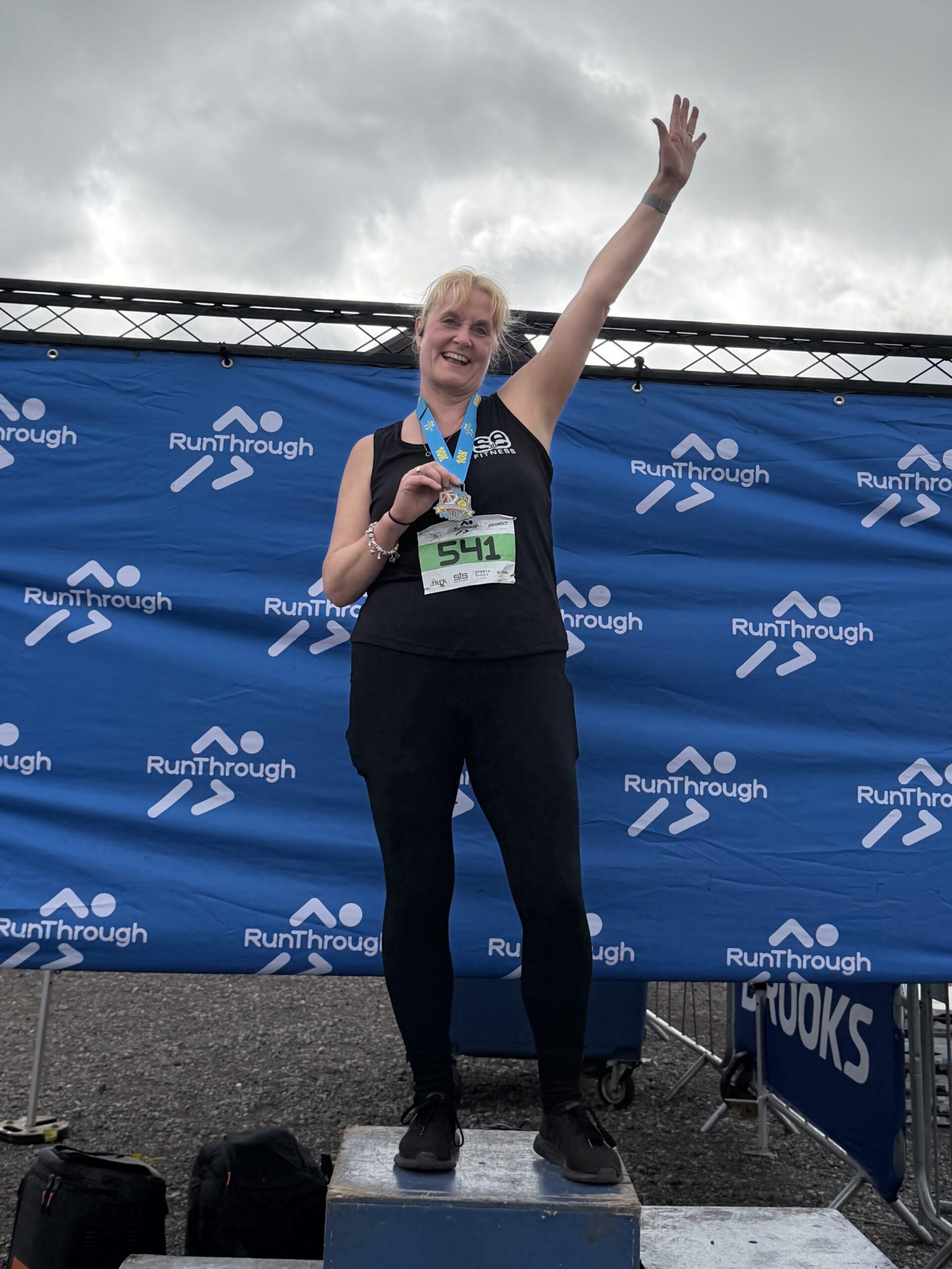 Claire With Her 10K Medal On The Podium
